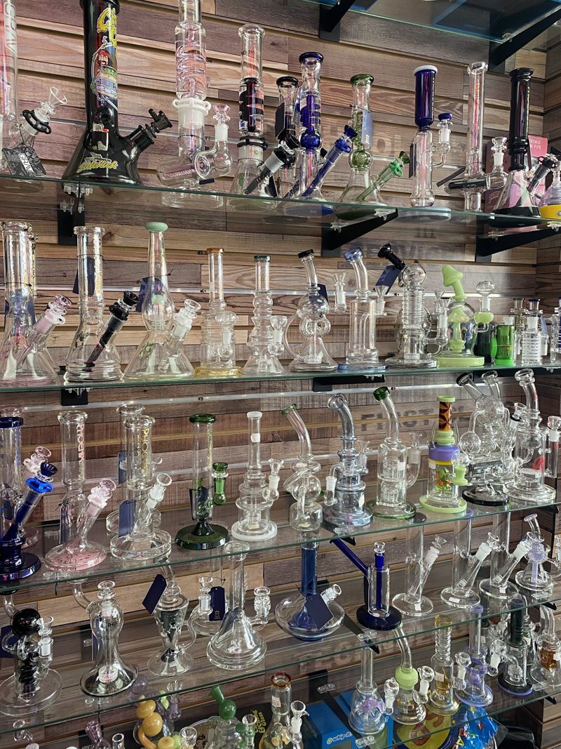 Glass pipes and water pipes on the wall at Spark & Smoke in Wylie, TX